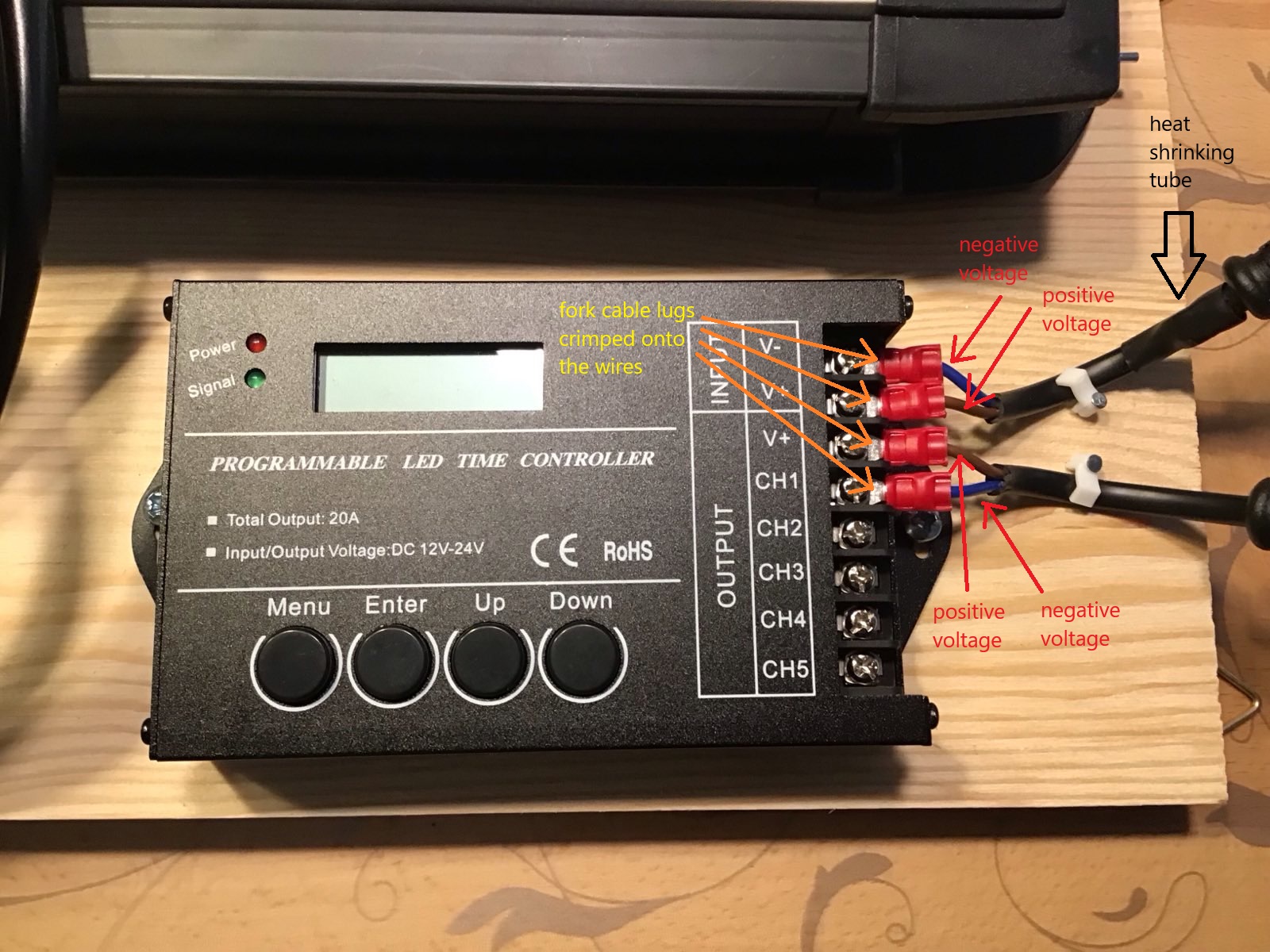 A closeup of the controller mounted to the wooden board.